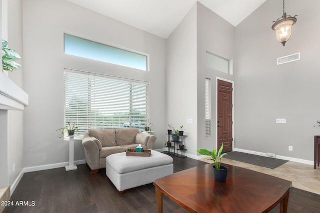 living room featuring dark hardwood / wood-style floors and high vaulted ceiling