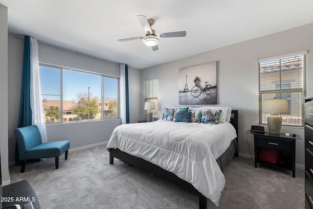 bedroom featuring multiple windows, ceiling fan, and carpet