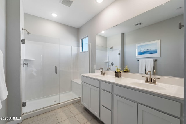 bathroom with vanity, an enclosed shower, and tile patterned floors