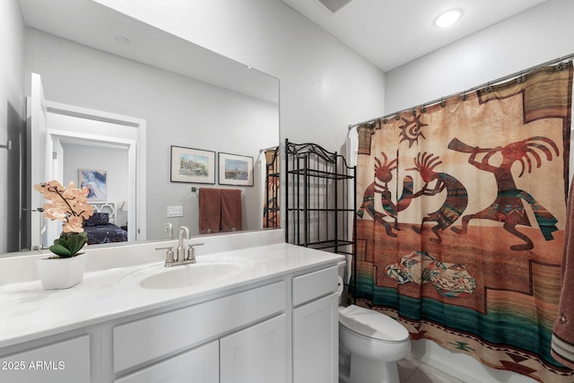 full bathroom with vanity, shower / bath combination with curtain, and toilet