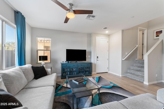 living room featuring ceiling fan and light hardwood / wood-style floors