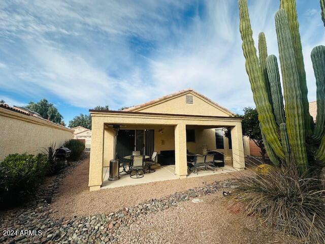 rear view of house featuring a patio