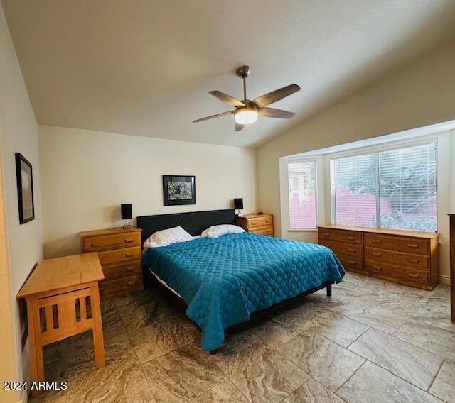 bedroom featuring ceiling fan and lofted ceiling