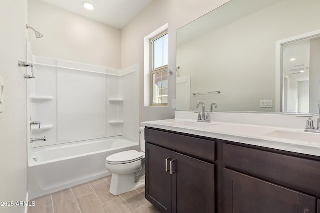 full bathroom featuring shower / bath combination, toilet, and vanity