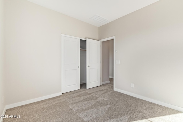 unfurnished bedroom featuring a closet and light carpet