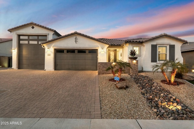 mediterranean / spanish-style home with a garage