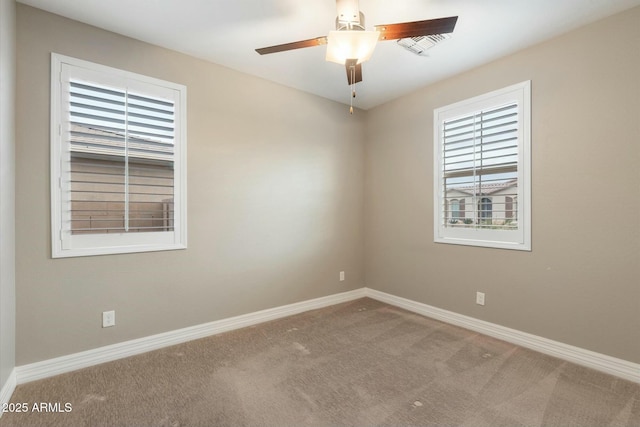 spare room featuring ceiling fan and carpet floors