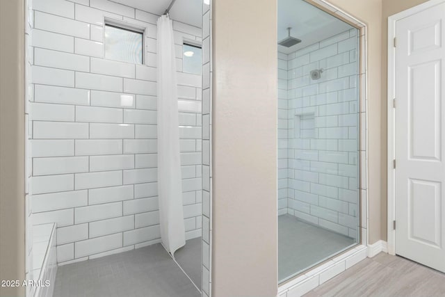 bathroom with hardwood / wood-style flooring and tiled shower