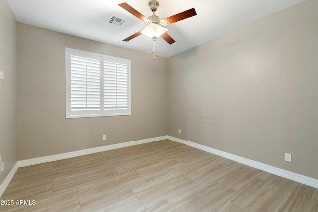 spare room with light wood-type flooring and ceiling fan