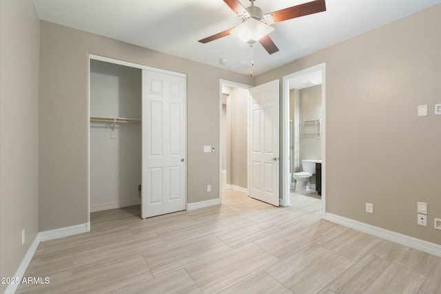 unfurnished bedroom with ceiling fan, a closet, and ensuite bathroom