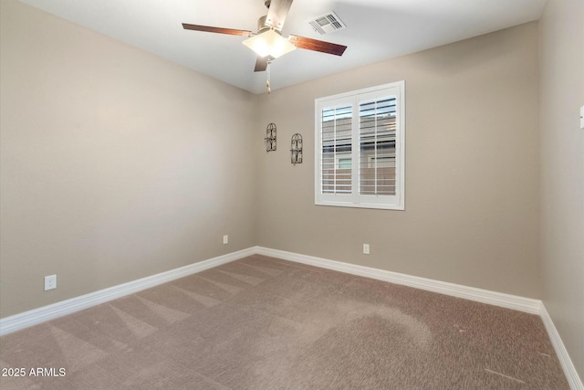 unfurnished room with ceiling fan and carpet