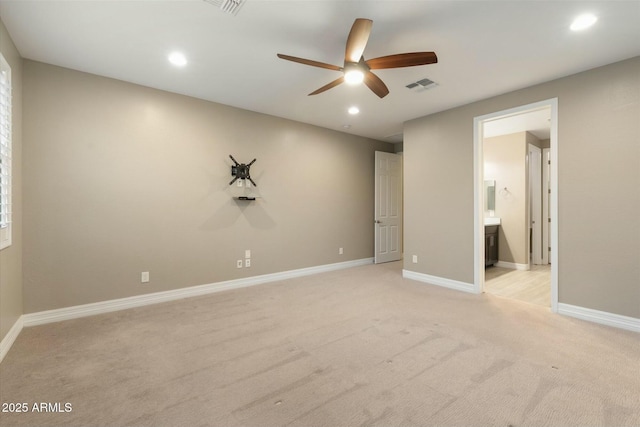 unfurnished bedroom featuring ceiling fan, connected bathroom, and light colored carpet