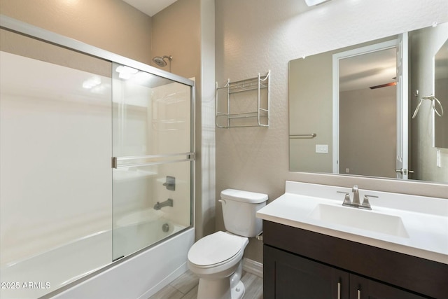 full bathroom featuring enclosed tub / shower combo, vanity, wood-type flooring, and toilet