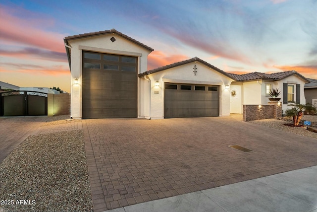 mediterranean / spanish-style house with a garage