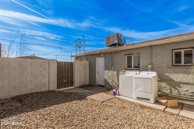 exterior space with cooling unit and washing machine and dryer