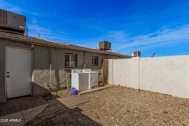 view of yard with washing machine and dryer and central air condition unit