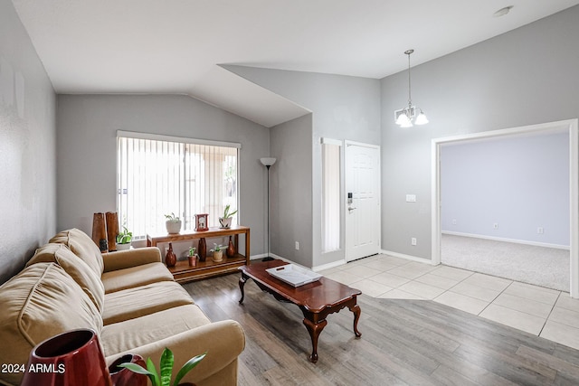 living room with light tile patterned flooring, lofted ceiling, and an inviting chandelier