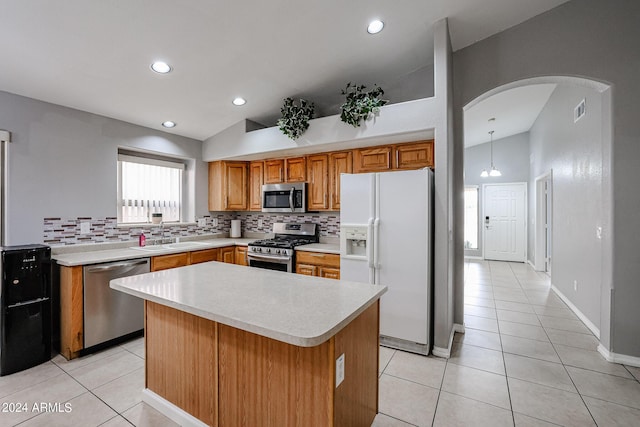 kitchen featuring pendant lighting, a center island, sink, tasteful backsplash, and stainless steel appliances