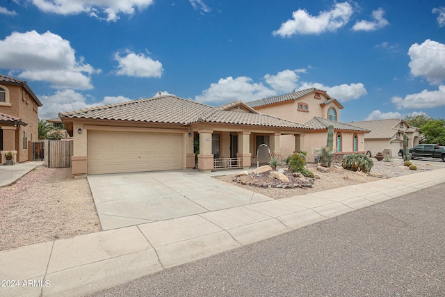 mediterranean / spanish home featuring a garage