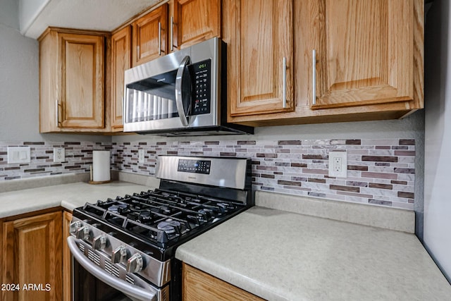 kitchen with decorative backsplash and stainless steel appliances