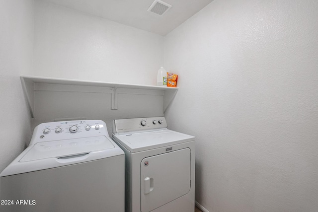 laundry area with independent washer and dryer