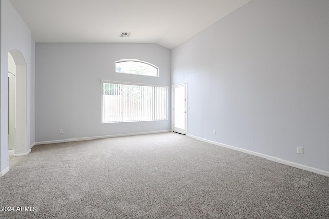 unfurnished room with light carpet and vaulted ceiling