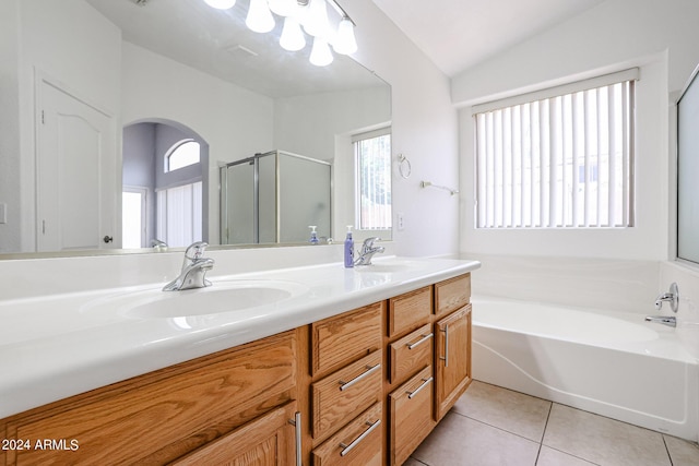 bathroom with tile patterned floors, vanity, lofted ceiling, and independent shower and bath