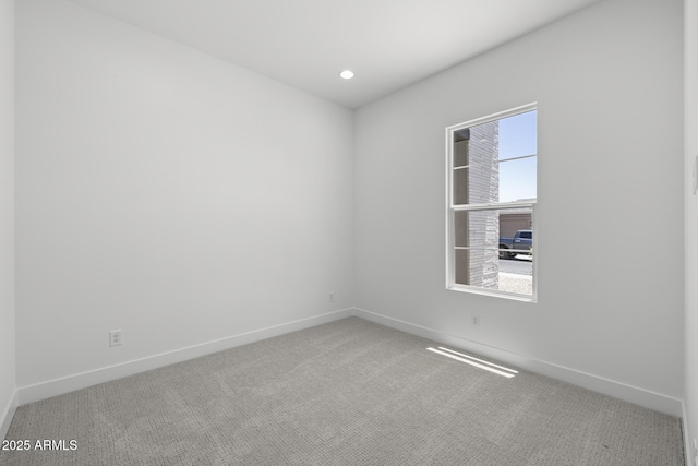 spare room featuring carpet floors, recessed lighting, visible vents, and baseboards