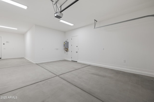 garage with baseboards and a garage door opener