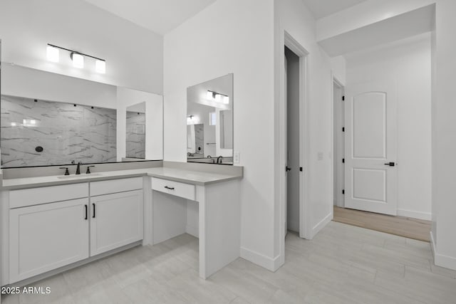 full bathroom with baseboards, a marble finish shower, vanity, and decorative backsplash