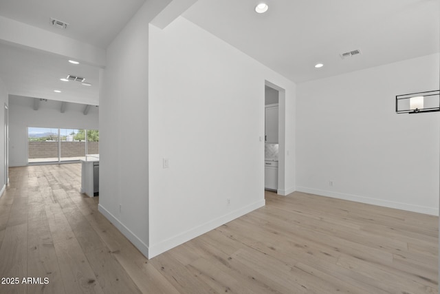 hallway featuring light wood-style floors, recessed lighting, visible vents, and baseboards