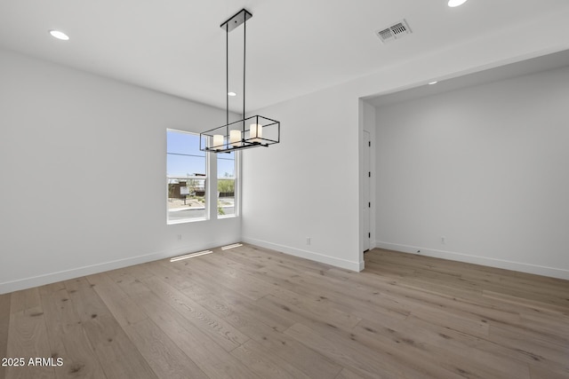 unfurnished dining area featuring light wood-type flooring, baseboards, visible vents, and recessed lighting