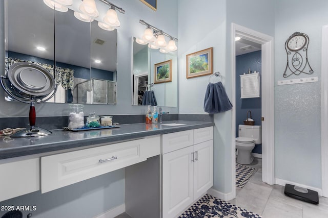 full bathroom with vanity, toilet, baseboards, and tile patterned flooring