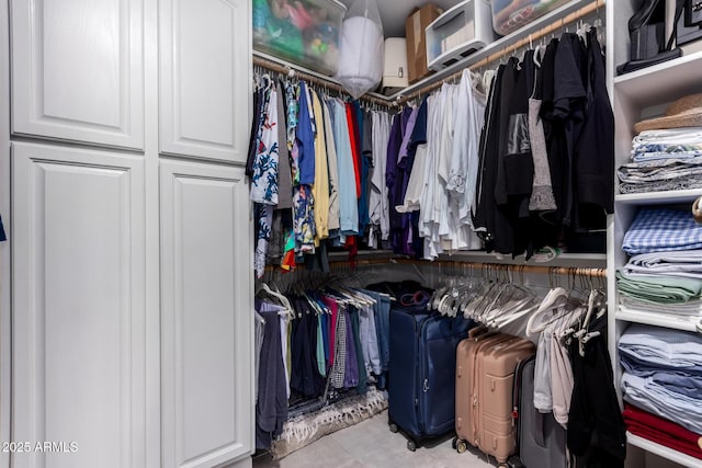 spacious closet with tile patterned floors