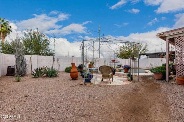 view of yard featuring a patio and a fenced backyard