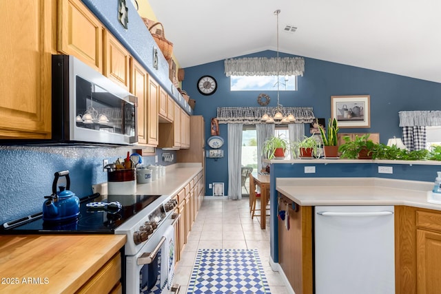 kitchen with stainless steel microwave, dishwasher, light countertops, an inviting chandelier, and electric range