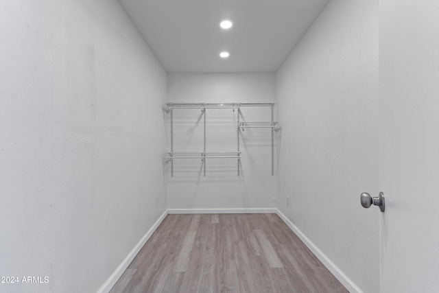 walk in closet with light wood-type flooring