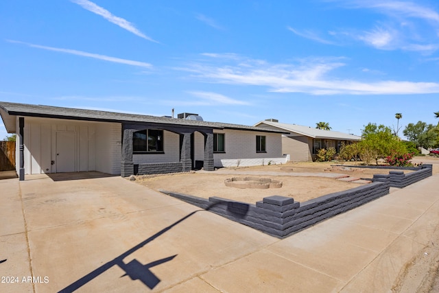 back of property featuring a carport