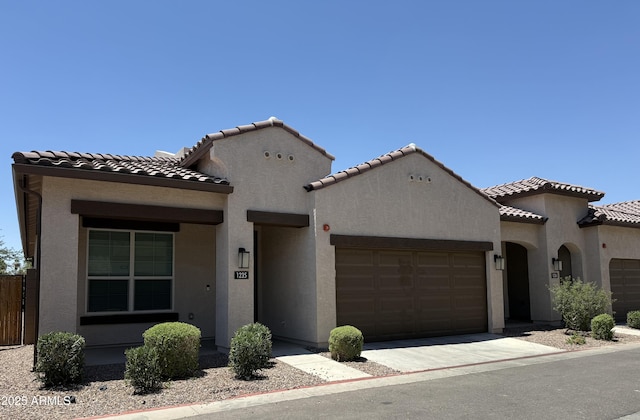 1255 N Arizona Ave Unit 1235, Chandler, AZ 85225 - mediterranean / spanish-style house with an attached garage, stucco siding, and a tile roof