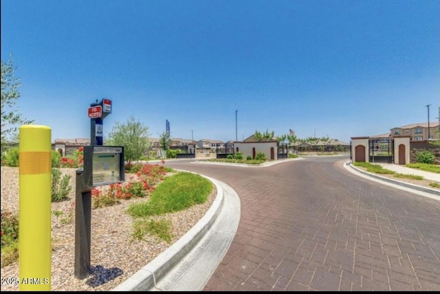 1255 N Arizona Ave Unit 1235, Chandler, AZ 85225 - view of road featuring curbs and a gated entry