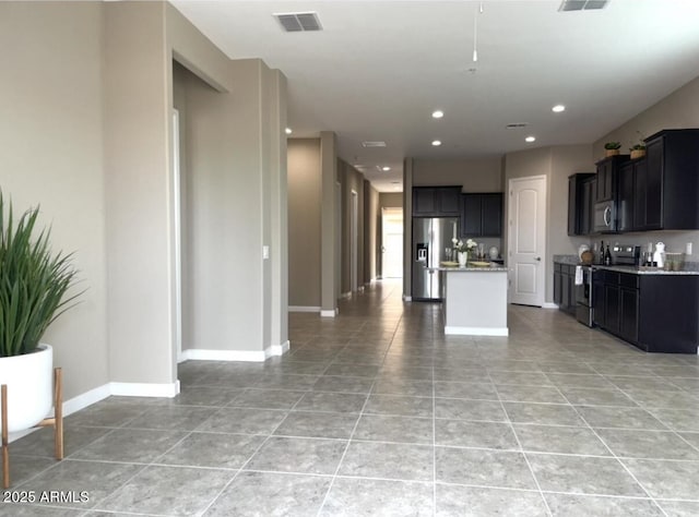 1255 N Arizona Ave Unit 1235, Chandler, AZ 85225 - kitchen featuring appliances with stainless steel finishes, light tile patterned floors, a center island, open floor plan, and recessed lighting