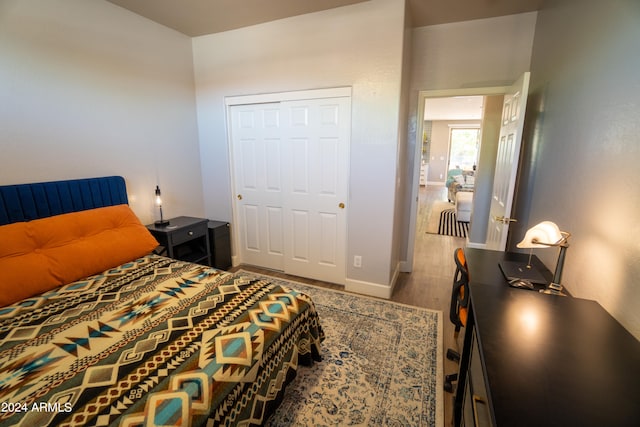 bedroom with a closet and hardwood / wood-style flooring