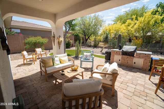 view of terrace featuring exterior kitchen, an outdoor hangout area, and grilling area