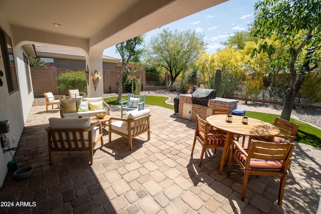 view of patio / terrace with outdoor lounge area and a grill