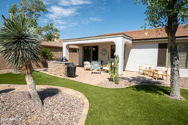 back of house featuring a patio area, an outdoor hangout area, and a lawn