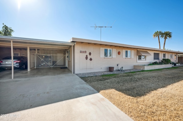 ranch-style home with a carport and a front yard