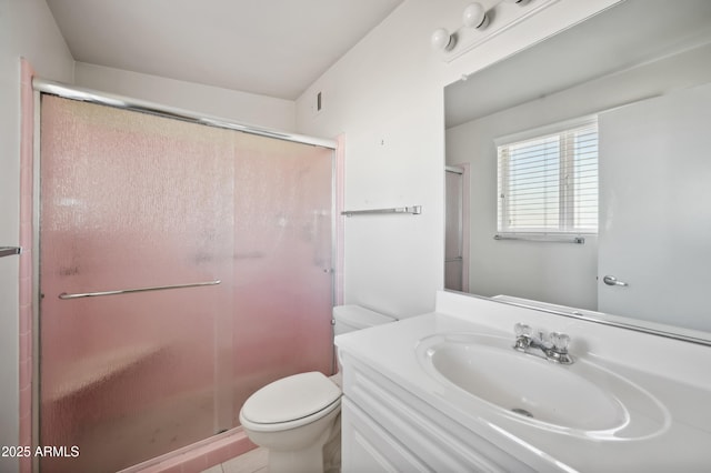 bathroom featuring vanity, toilet, and walk in shower