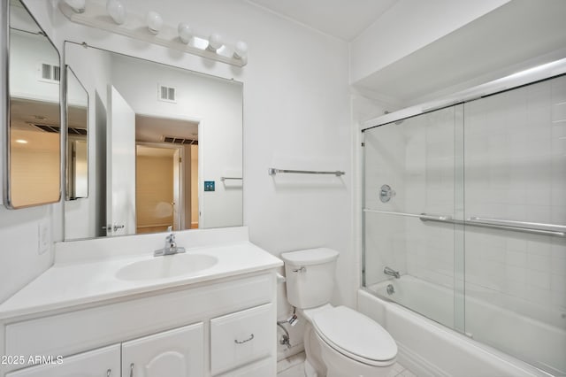 full bathroom with shower / bath combination with glass door, vanity, and toilet