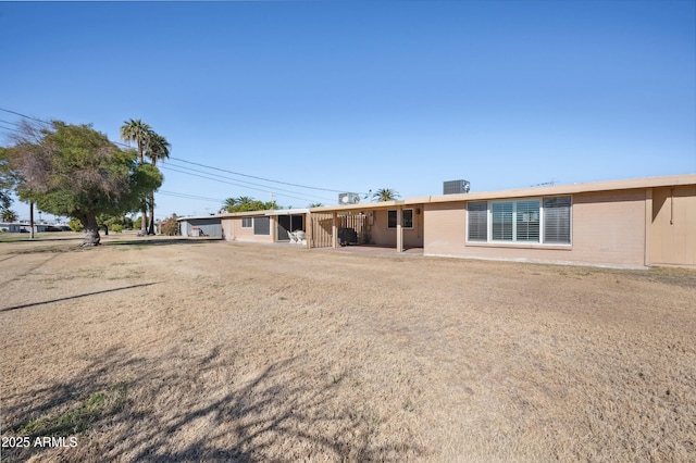 rear view of property with central AC unit