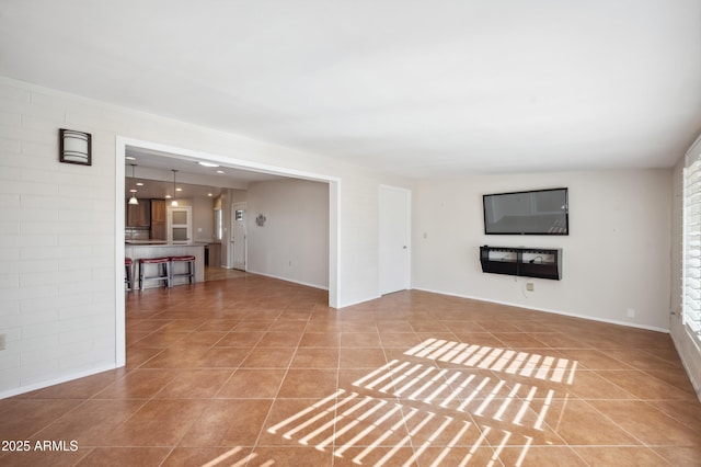 unfurnished living room featuring tile patterned floors